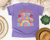 Teaching Tiny Humans To Do Big Things graphic tee in Violet
