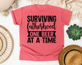 Surviving Fatherhood One Beer At A Time White graphic tee in Watermelon