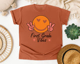 First Grade Vibes Smiley graphic tee in Yam