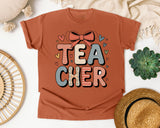 Teacher Stacked Bow Graphic Tee graphic tee in Yam