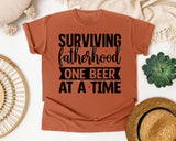 Surviving Fatherhood One Beer At A Time White graphic tee in Yam