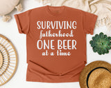 Surviving Fatherhood One Beer At A Time Classic graphic tee in Yam