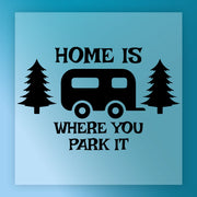 a black RV symbol and the text "HOME IS WHERE YOU PARK IT" against a blue background.