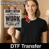 A woman holding a sign with the text "DON'T WISH FOR IT WORK FOR IT" and a red arrow pointing to her chest.