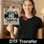 A woman is holding up a sign with the text "Soccer Squad" and a red arrow pointing to her chest, indicating that the sign is a custom design.