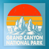 The InkMerge Retro Desert Sunset Adventure DTF transfer features a stylized illustration of rocky mountain peaks and a retro orange-yellow striped sun, with “Grand Canyon National Park” in bold white letters beneath.