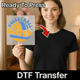 A smiling woman holding a sign with a volleyball design, and there is a red arrow pointing to her chest.