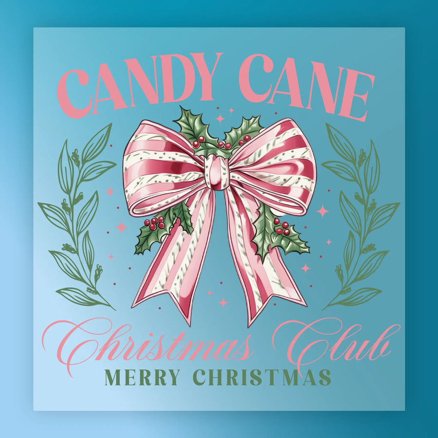 The Candy Cane Christmas Club Design by InkMerge features a pink and white striped bow with holly and berries on a blue background framed by green leaves. Text: "Candy Cane Christmas Club Merry Christmas". Great for holiday heat press or DTF film transfers.