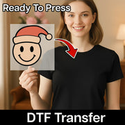 A woman in a black shirt holds a clear sheet with the Smiley Face Santa Hat Design by InkMerge. "Ready To Press" is at the top, "DTF transfer" at the bottom, and a red arrow highlights easy application with a heat press.