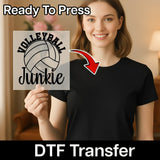 A woman is holding up a sign with the text "Volleyball Junkie" on it, and there is a red arrow pointing to the sign.