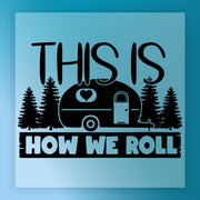 The InkMerge "This Is How We Roll Camper Design - Heat Press Ready" features the phrase above and below a cute camper with heart, pine trees, and a blue background—ideal for your next heat press or DTF transfer project.