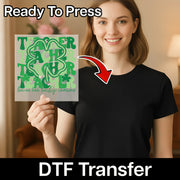 A woman is holding a green sign with the text "TACHER TACHER TACHER" on it, and there is a red arrow pointing to her chest.