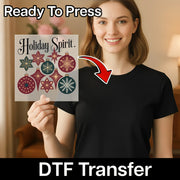 A smiling woman in a black shirt holds an InkMerge Holiday Spirit Vintage Ornaments DTF transfer sheet. An arrow points to her shirt, with text: "Ready To Press, DTF Transfer—ideal for creating custom apparel.