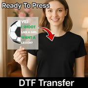 A woman holding a sign with a soccer ball and text on it, with a red arrow pointing to her chest.