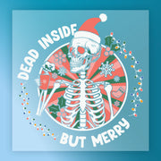 The InkMerge Dead Inside But Merry Skeleton Christmas design features a skeleton in a Santa hat with a mug and twinkling lights—perfect for ugly sweater parties or festive DTF transfers.