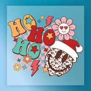 The HO HO HO Festive Design by InkMerge features a smiling chocolate chip cookie in a Santa hat, surrounded by flowers, stars, lightning bolts, and a blue-pink checkerboard—ideal for festive decor or DTF transfers.
