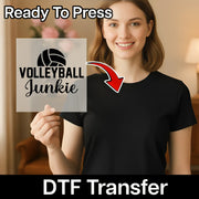 A smiling woman holding a sign that says "Volleyball Junkie" with a red arrow pointing to it.