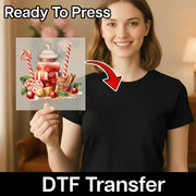 A smiling woman in a black shirt holds up InkMerge’s Festive Holiday Candy Scene DTF transfer, featuring candy canes, sweets, holly, cherries, and cinnamon sticks. Ready to press—ideal for custom apparel! Text reads "Ready To Press" and "DTF Transfer.