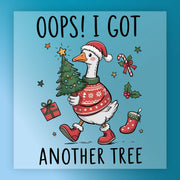 The InkMerge “Oops I Got Another Tree Goose” features a goose in a Santa hat, red sweater, and boots carrying a Christmas tree, surrounded by festive items—ideal for DTF transfer with your heat press! Text: "Oops! I got another tree.