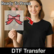 A smiling woman in a black t-shirt holds InkMerge's Elegant Red Bow Design heat press transfer. A clear sheet with the bow is shown, with a red arrow pointing to her shirt. "Ready To Press" appears at the top, and "heat press transfer" at the bottom.