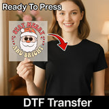 A smiling woman in a black shirt holds InkMerge’s Stay Merry And Bright Santa Sunglasses DTF transfer, perfect for an ugly sweater party. Candy canes and an arrow highlight her shirt. Text: Ready To Press and DTF Transfer.