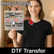 A woman is holding up a Halloween-themed sign with text that says "SPOOKY -GHOULS CANDY BATS CREAMY HALLOWEEN Witches Boo HATED TRICK OR TREAT".
