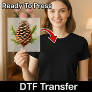 A smiling woman in a black shirt holds a transparent sheet featuring InkMerge’s Pine Cone Watercolor Design. Text reads Ready To Press above and DTF Transfer below with a red arrow—great for custom apparel projects.