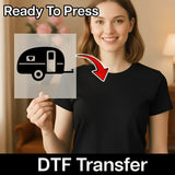 A woman holding a transparent sign with a black and white illustration of a camper trailer on it, with a red arrow pointing to the camper trailer.