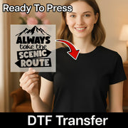 A smiling woman in a black t-shirt holds InkMerge's "Always Take the Scenic Route" DTF transfer sheet with an arrow. Overlay text: Ready To Press and DTF Transfer.