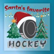 Santa's Favorite Hockey Design by InkMerge features a hockey puck in a Santa hat, festive trees, and string lights with "Santas favorite hockey" text on blue—perfect for custom apparel via heat press or DTF transfers.
