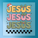 The InkMerge Jesus Christmas Design DTF transfer features "JESUS" written three times in large letters. Each “U” has holly, the top “J” has a Santa hat, and the design includes yellow, pink, green, and black squares at the bottom.