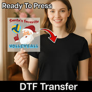 A smiling woman in a black shirt holds InkMerge's Santa's Favorite Volleyball - Heat Press Ready transfer, featuring a cartoon Santa with a volleyball and the text "ready to press" above.