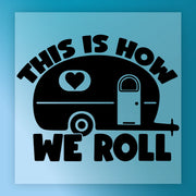 The This Is How We Roll Camper Design by InkMerge features a camper trailer with a heart and bold lettering on a blue background—ideal for vibrant custom apparel using DTF transfers or heat press.