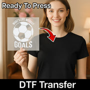 A woman holding a sign with the text "What's Life Without Goals" and a soccer ball graphic, with a red arrow pointing to her chest.