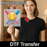 A woman holding a sign with a baseball graphic and a red arrow pointing to it, with the text "Ready To Press" and "DTF Transfer" below the image.