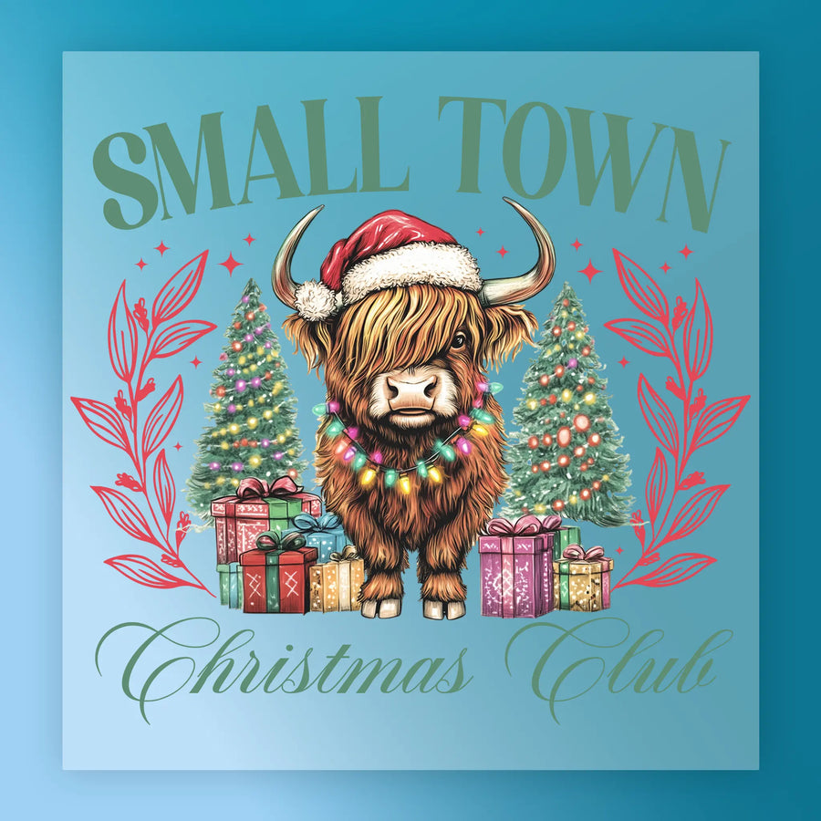 The InkMerge Small Town Christmas Club Highland Cow features a Highland cow in a Santa hat and Christmas lights, standing by decorated trees and gifts with "Small Town Christmas Club" text above—ideal for festive DTF transfers.
