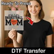 A woman holding a sign with the text "Ready To Press senior basketball mom" and a red arrow pointing to her chest.