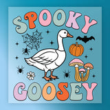 The image is a colorful illustration featuring a cartoon goose surrounded by various Halloween-themed elements, including a spider, pumpkin, mushrooms, and a bat.