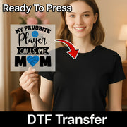 A woman holding a sign with text that says "My favorite player calls me mom" and a red arrow pointing to her chest.