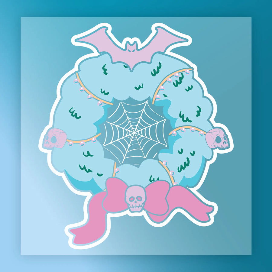 The InkMerge Gothic Holiday Wreath with Skulls and Bat DTF transfer features teal, pink skulls, string lights, a spider web, and a pink bat—perfect for creating standout Halloween apparel with a unique gothic twist.