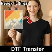 A smiling woman in a black shirt holds an InkMerge Retro Geometric Pattern DTF Transfer sheet with a mountain and sun design. "Ready To Press" appears at the top, "DTF Transfer" at the bottom, and an arrow points to her shirt.
