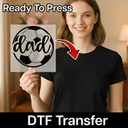 A woman holding a sign with the word "dad" on it, smiling and posing for the camera.
