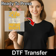 A smiling woman in a black t-shirt holds the InkMerge Hiking Boots - Heat Press Ready DTF transfer sheet featuring "Life is better in hiking boots" and a boot graphic. "Ready To Press" and ideal for your next heat press project.