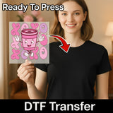 A woman holding a transparent image of a cartoon character with a pink cup, and there is text that says "Ready To Press" and "DTF Transfer" below the image.