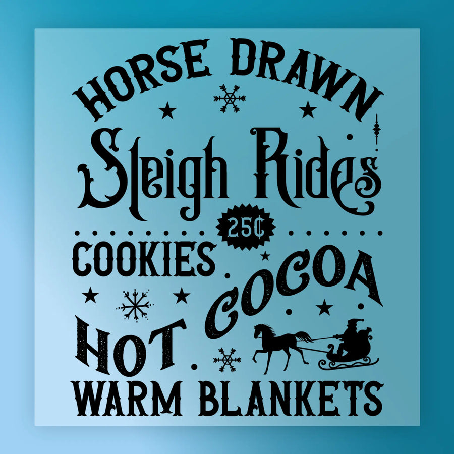 The InkMerge Horse Drawn Sleigh Rides Vintage Design features black text on blue with snowflakes and a sleigh silhouette—reading "25¢, Cookies, Hot Cocoa, Warm Blankets." Perfect for heat press projects; arrives as a DTF transfer.