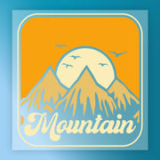 Retro-style minimalist landscape featuring three mountains, a rising sun, birds, and "Mountain" in bold script. Vibrant orange, yellow, and blue colors. Mountain Sunset Minimalist Landscape by InkMerge—DTF transfer, ready to press.