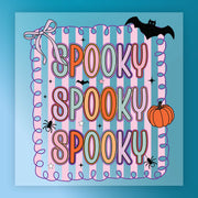 a colorful and whimsical Halloween-themed design with the text "SPOKEY SPOKEY SPOKEY" prominently displayed. The design includes various Halloween-related elements such as a bat, a pumpkin, and stars, creating a festive and spooky atmosphere.