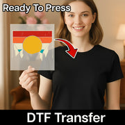 A woman in a black shirt holds InkMerge’s Good Vibes Retro Sunset DTF film with a yellow circle, red stripes, and blue triangles. "Ready To Press" and "DTF Transfer" appear with an arrow—perfect for your next heat press project.