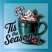 The "Tis the Season Cocoa Design" by InkMerge features a green mug of hot chocolate with whipped cream, two candy canes, and holly on a blue background—ideal for heat press or DTF transfer on premium DTF film.