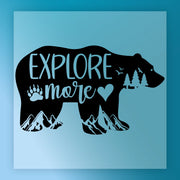 The Explore More Bear Adventure Design by InkMerge features a black bear silhouette with "Explore more," mountains, trees, birds, a paw print, and a heart on a light blue background—perfect for DTF transfer or heat press projects.